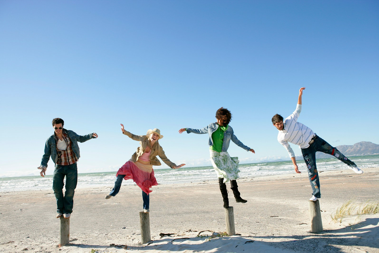 People balancing on posts